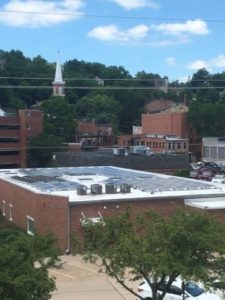 Photo of Local government flat roof solar array on brick building