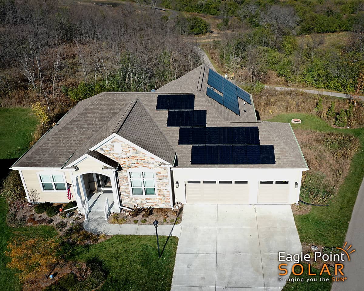 Aerial view of a home with solar panels on the roof: learn how solar panels affect property value in our article.