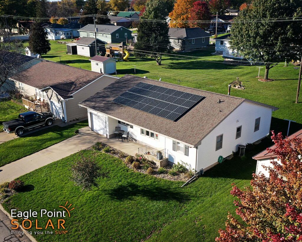 Residential solar panels on the roof of a white house.
