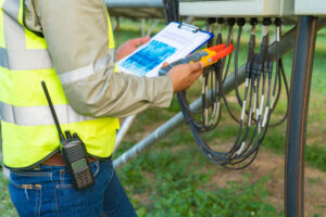 Image of a technician reading data about a solar array.