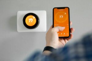 Man sets his thermostat through his smartphone to be more energy efficient
