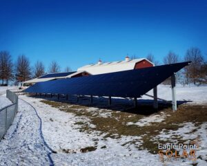 Solar panels both on the roof and situated next to a farm building
