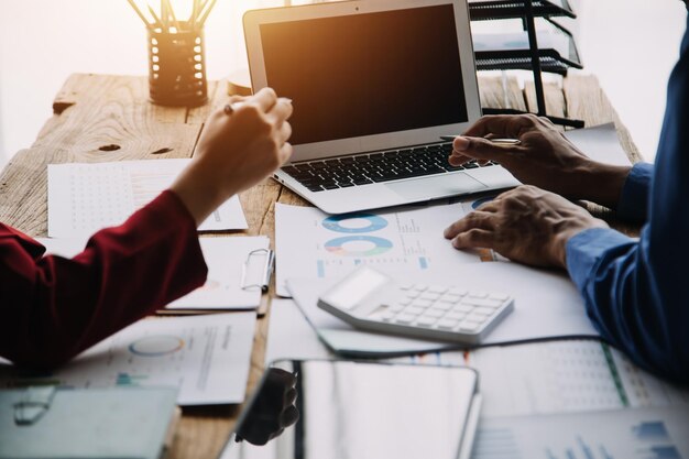 Two people reviewing charts and graphs. The more information you collect, the easier it is to avoid solar scams