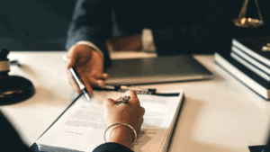 Two people signing contracts